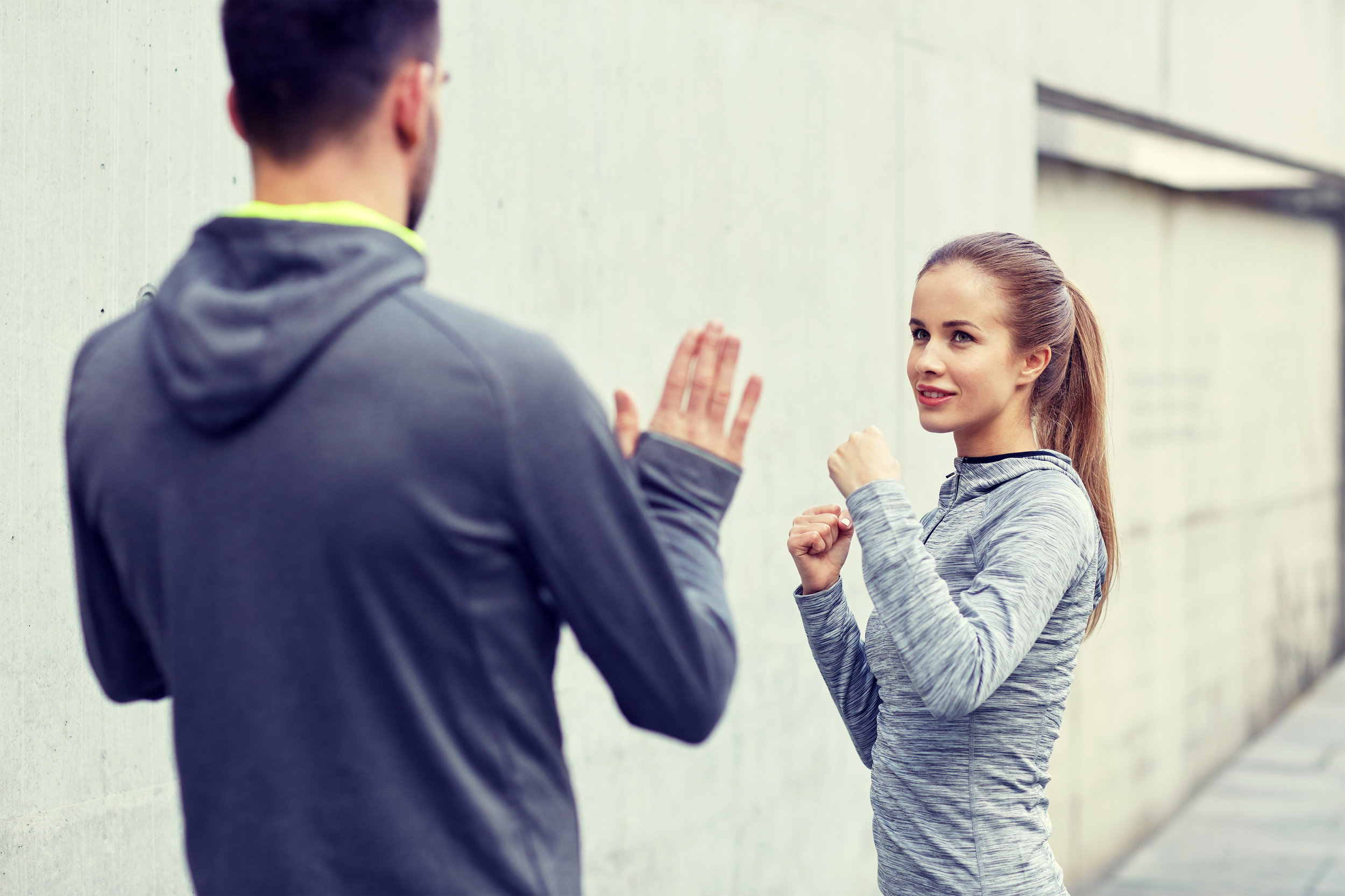 happy-woman-with-coach-working-out-strike-PK9S8BH.jpg