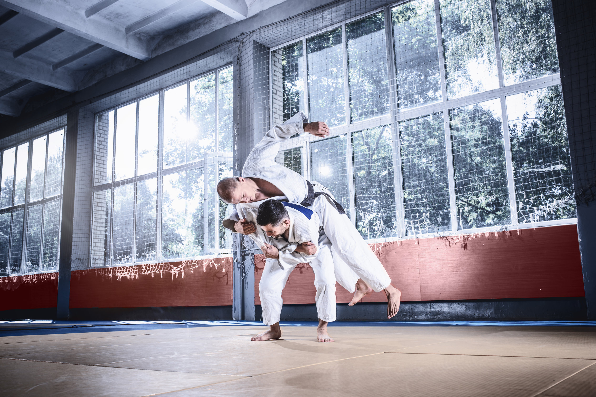 two-judo-fighters-showing-technical-skill-while-PJAUMD3.jpg