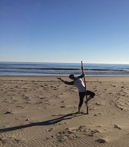 Man on the beach dancing with 1/12th of a faggot. 