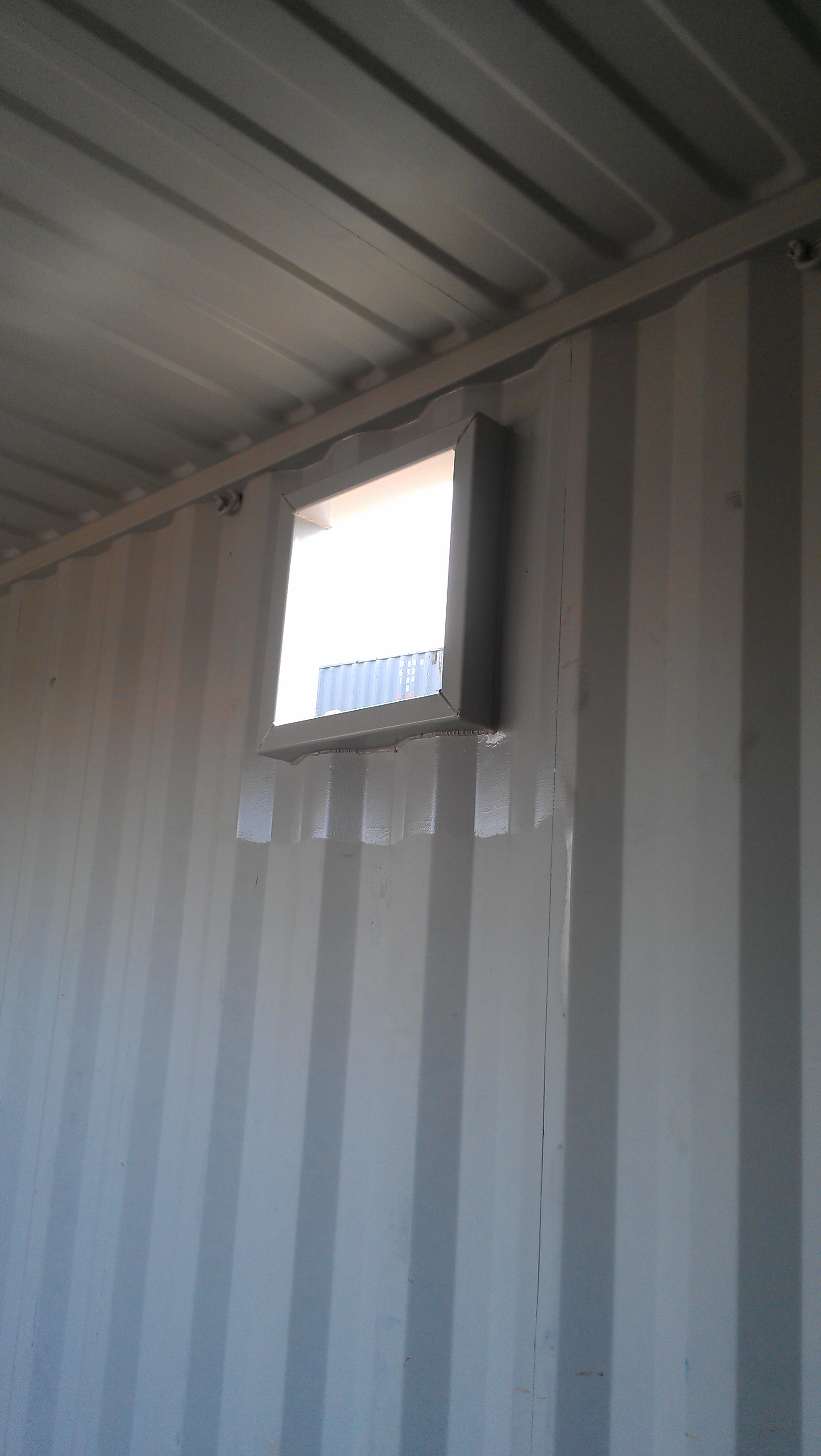 Cut and framed hole in container from inside