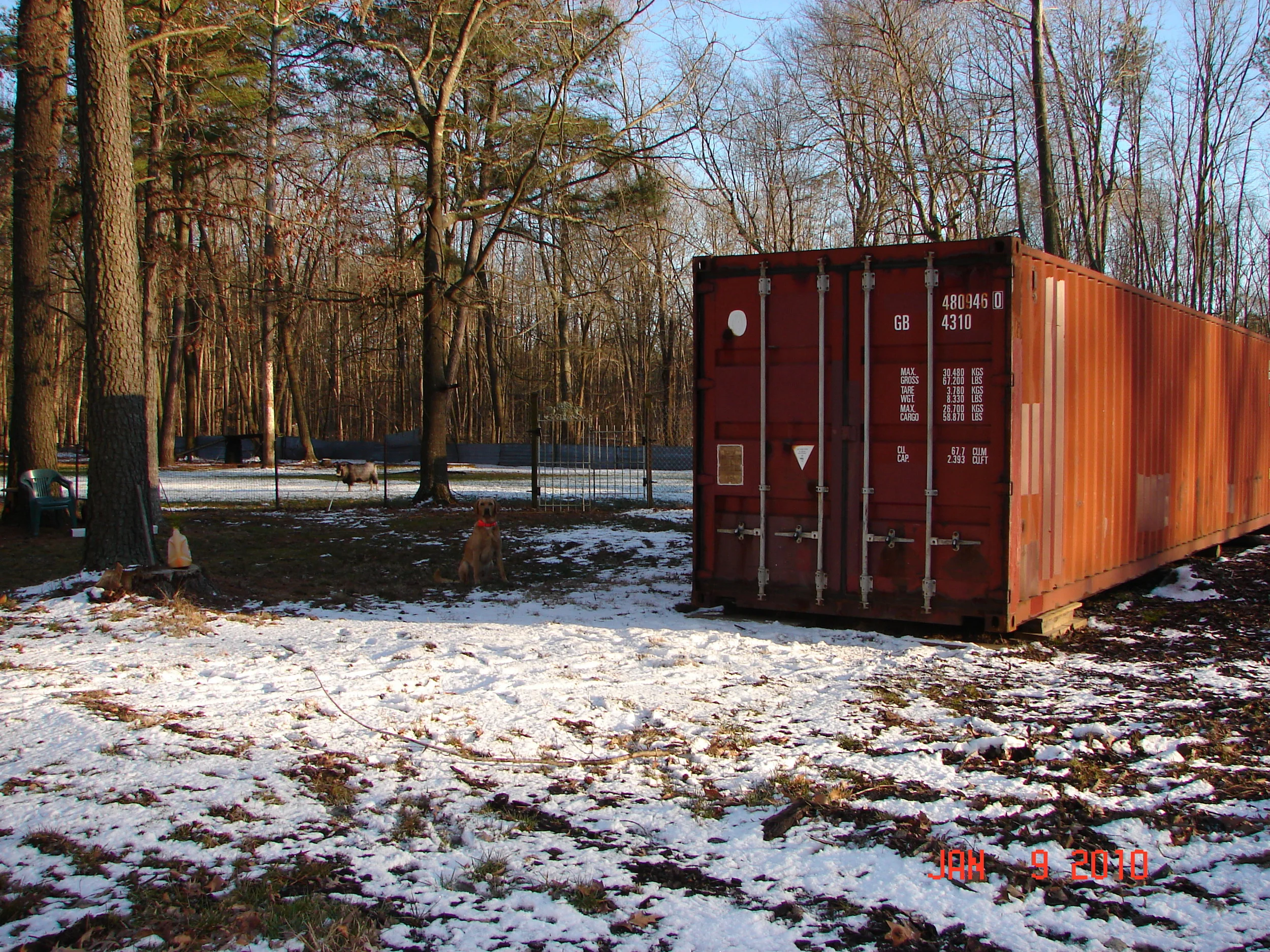 Orange 40' on customers land with dog and goat.jpg