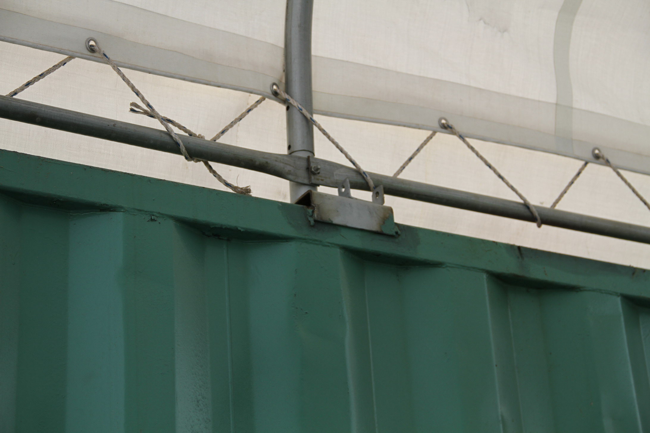 Roofing tarp ties onto frame.jpg