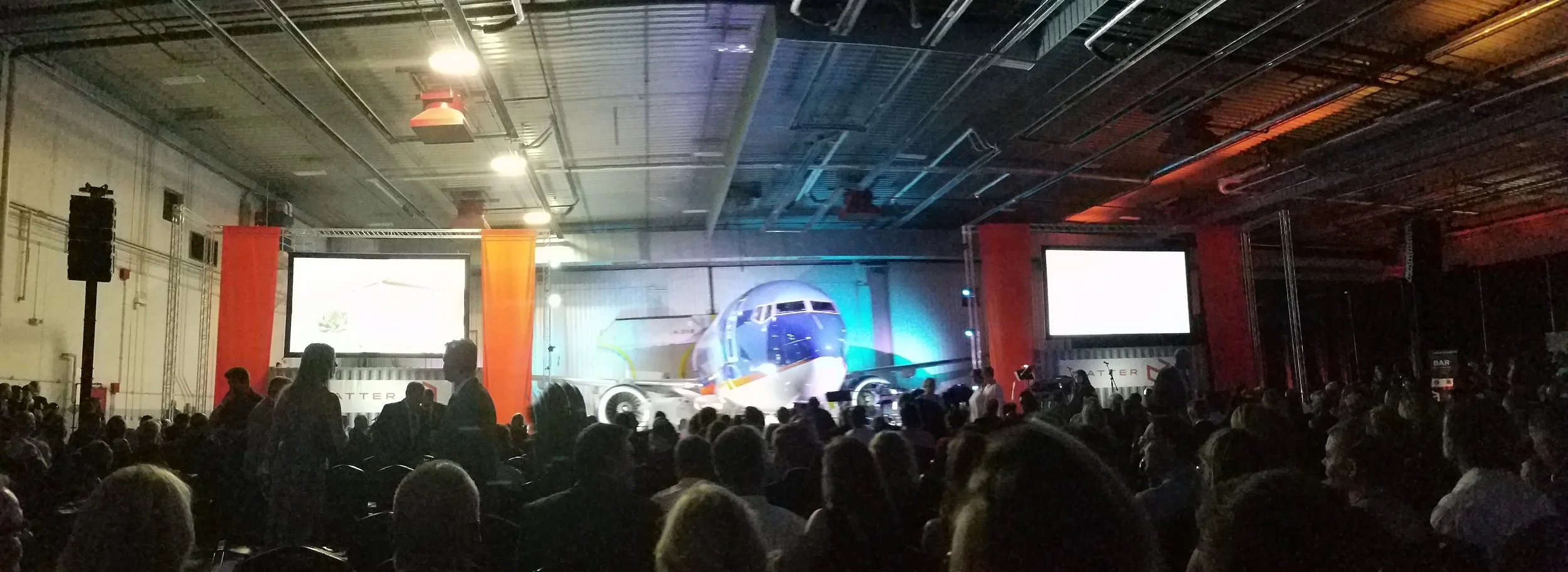 A Night to Matter at Sun Country's cargo hangar. The stage is set with containers and an airplane