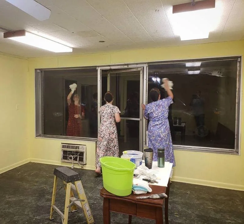 Members of the local Mennonite youth group help paint and clean the new Learning Center