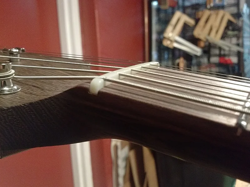 Slots are cut to depth, ends are trimmed, nut is shaped and polished.