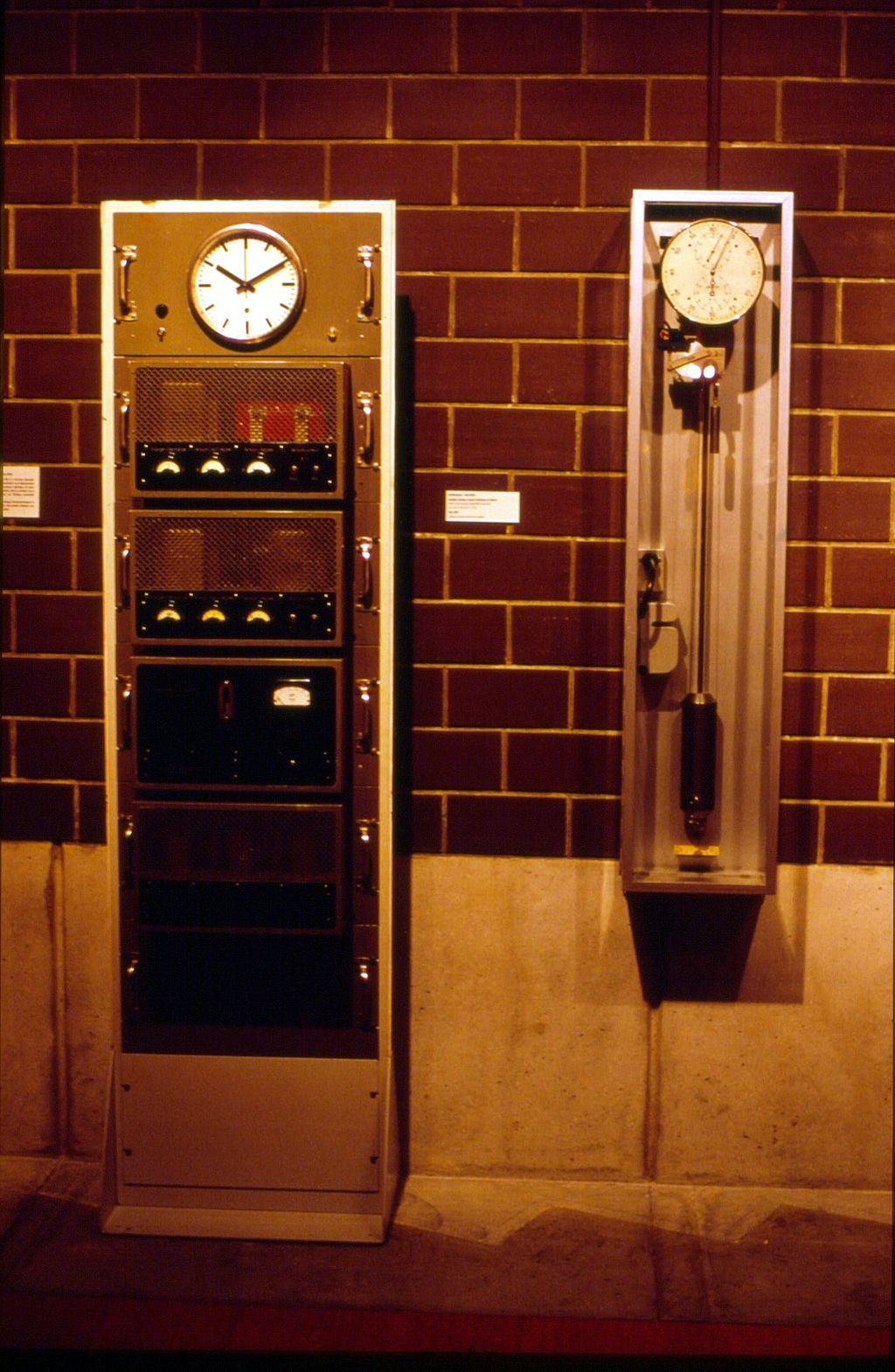 The first Swiss quartz clock, which was made after WW II (left), on display at the International Museum of Horology in La Chaux-de-Fonds.