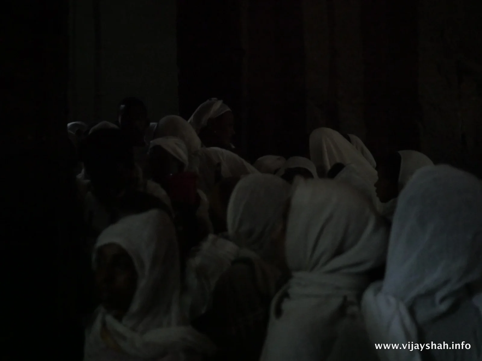 Crowds push past each other to enter the church.