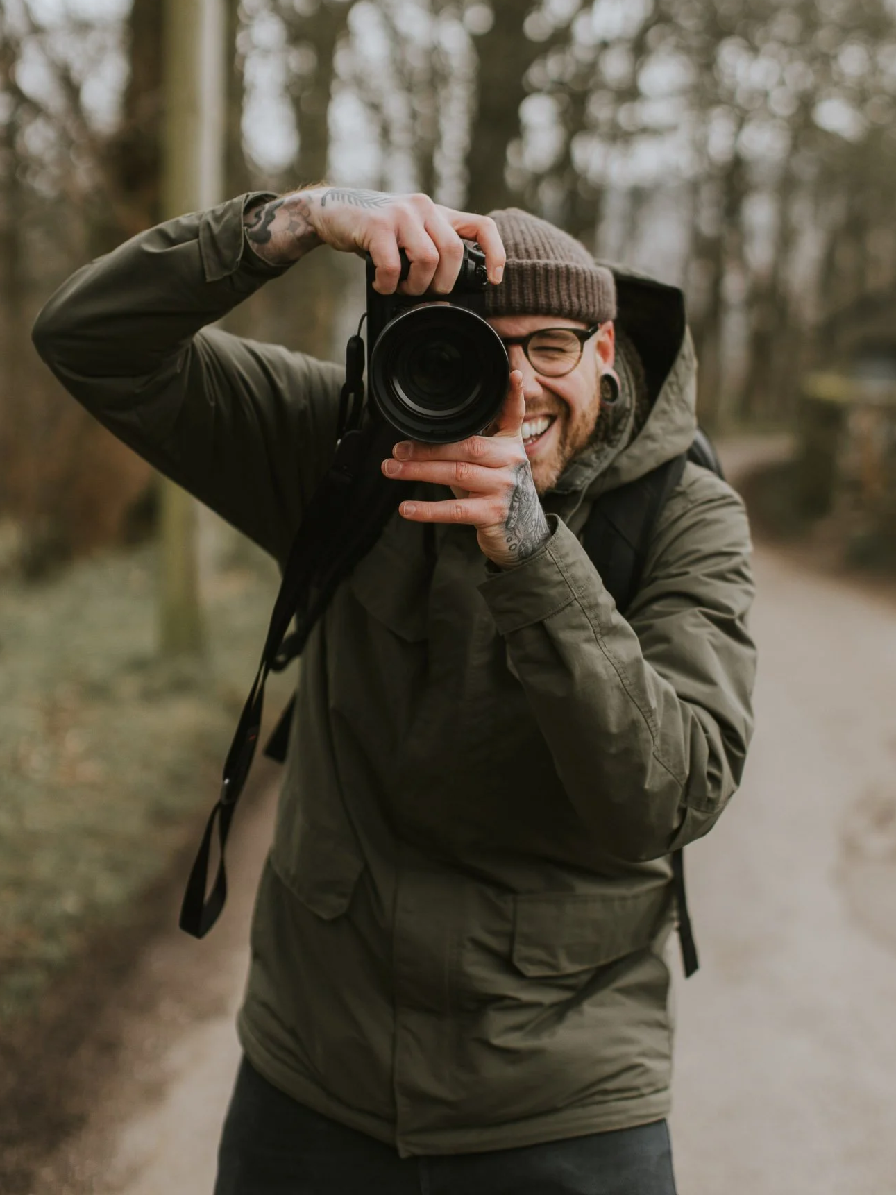 Image of Sheffield photographer Liam Rimmington smiling and holding a camera up to take a photo.