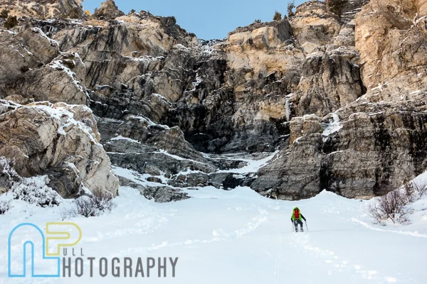Jake Hirschi hiking to the base of a project.