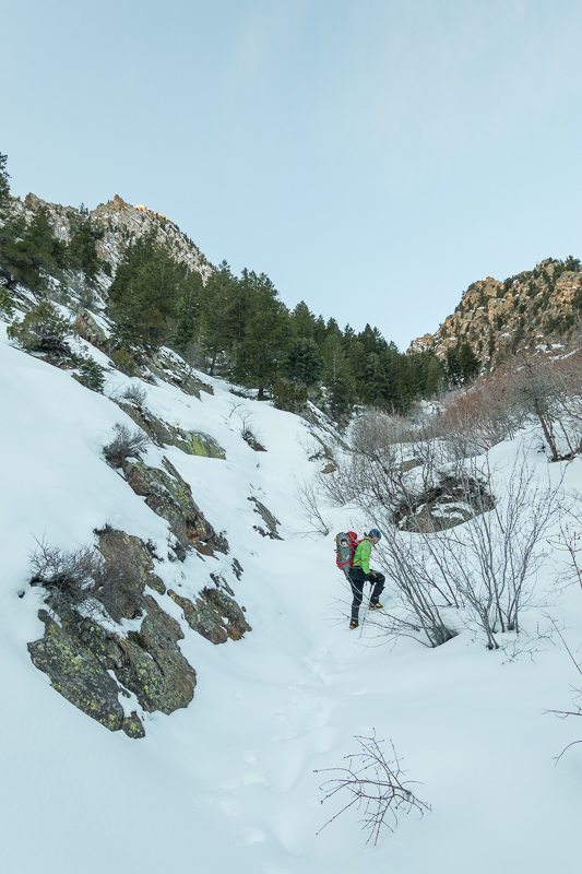 Jake starting up the avalanche gully leading to the base of the climb.