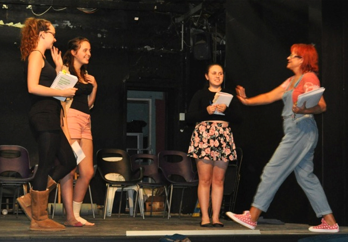 Teens busy themselves on the Garrick Theatre stage.