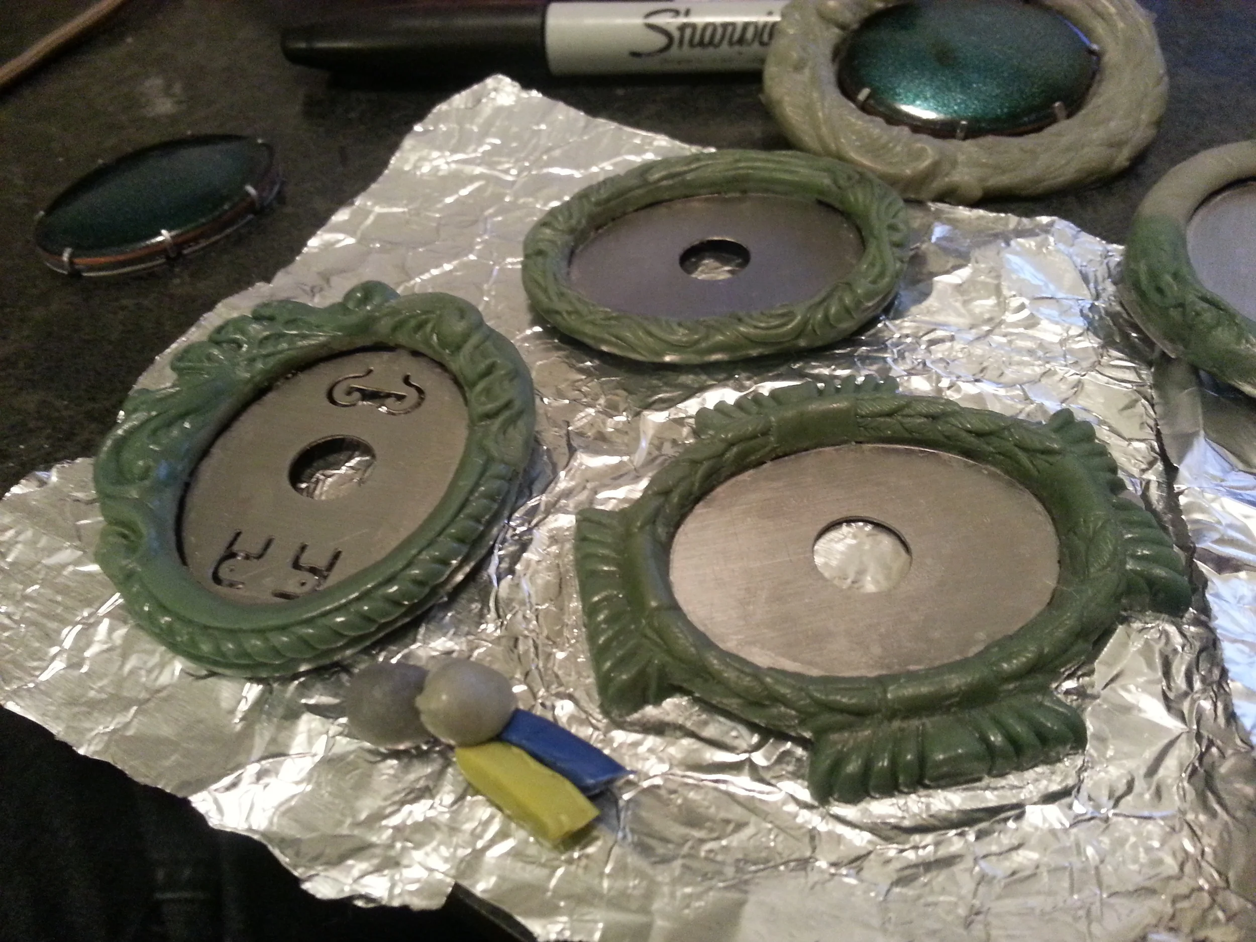 The blue, green, and gray bits at the front are the putties prior to mixing up. That's about the quantity I mix up at any given time, as the working period is about two hours before it starts getting too firm to easily sculpt.