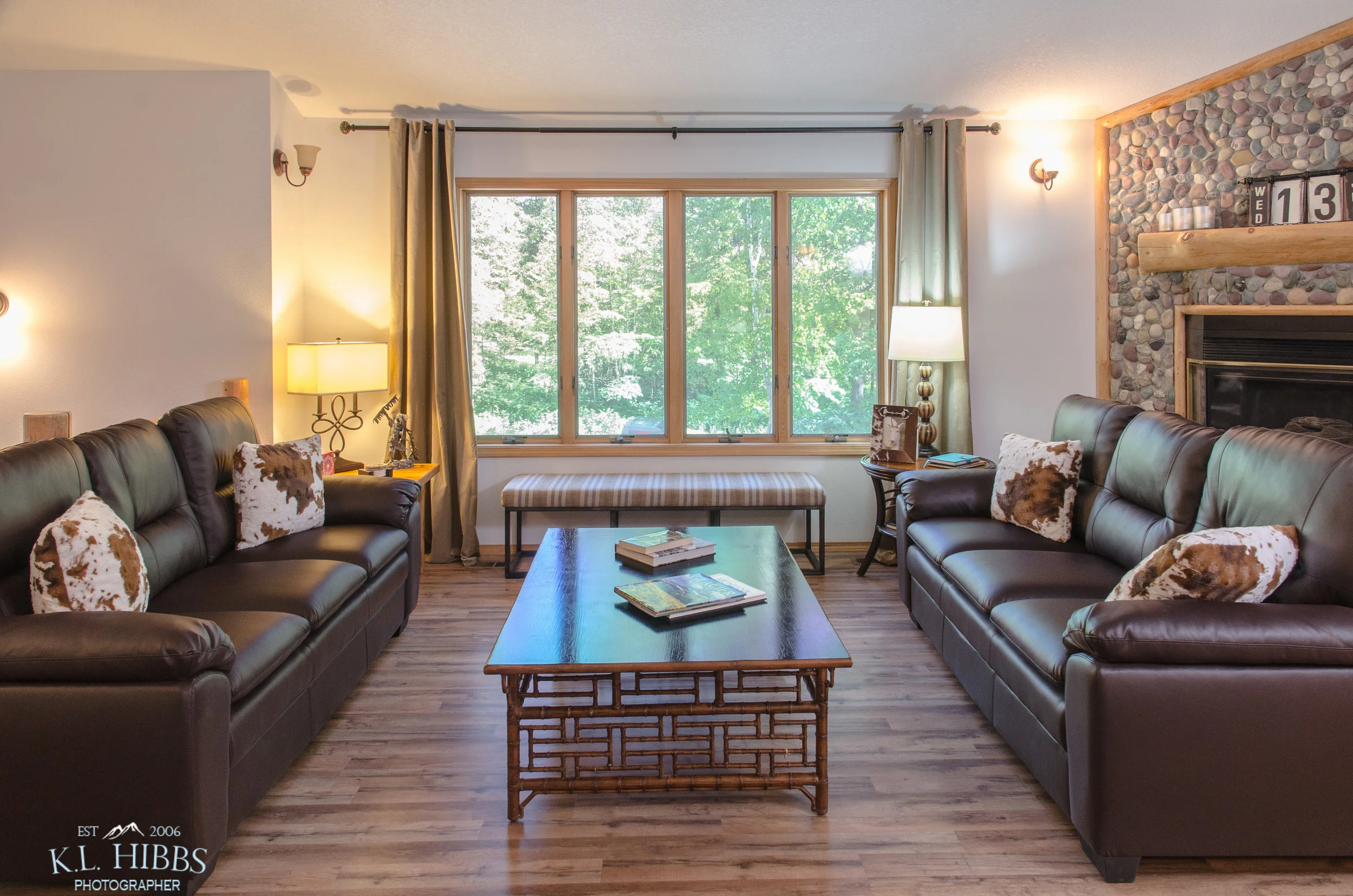 WELCOMING GREAT ROOM OFFERS BEAUTIFUL VIEWS OF THE MEADOW LAKE GOLF COURSE THROUGH THE TREES.
