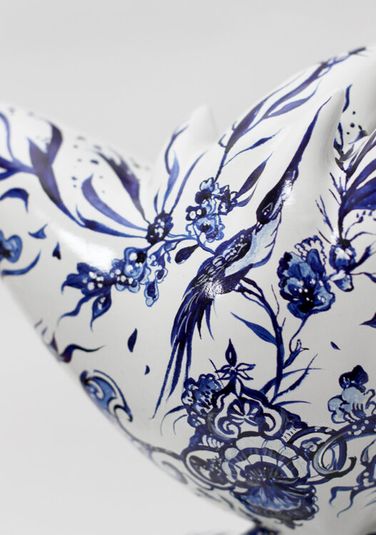 Detail of the hand-painted Pjipje sculpture highlighting floral ornament and swallow motif in Anna Sokolova's Contemporary Delft Blue style.