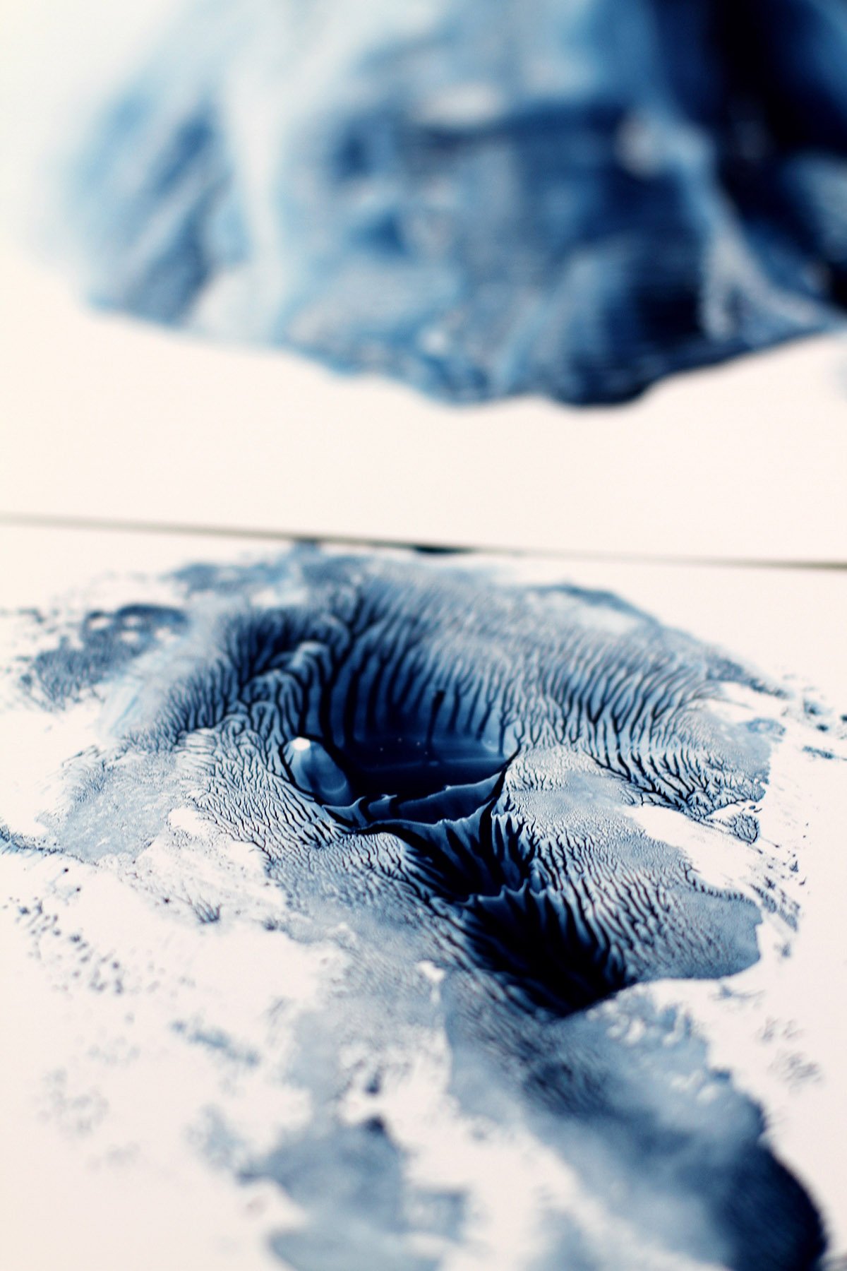 Abstract monotype in icy blue tones with intricate organic grooves.