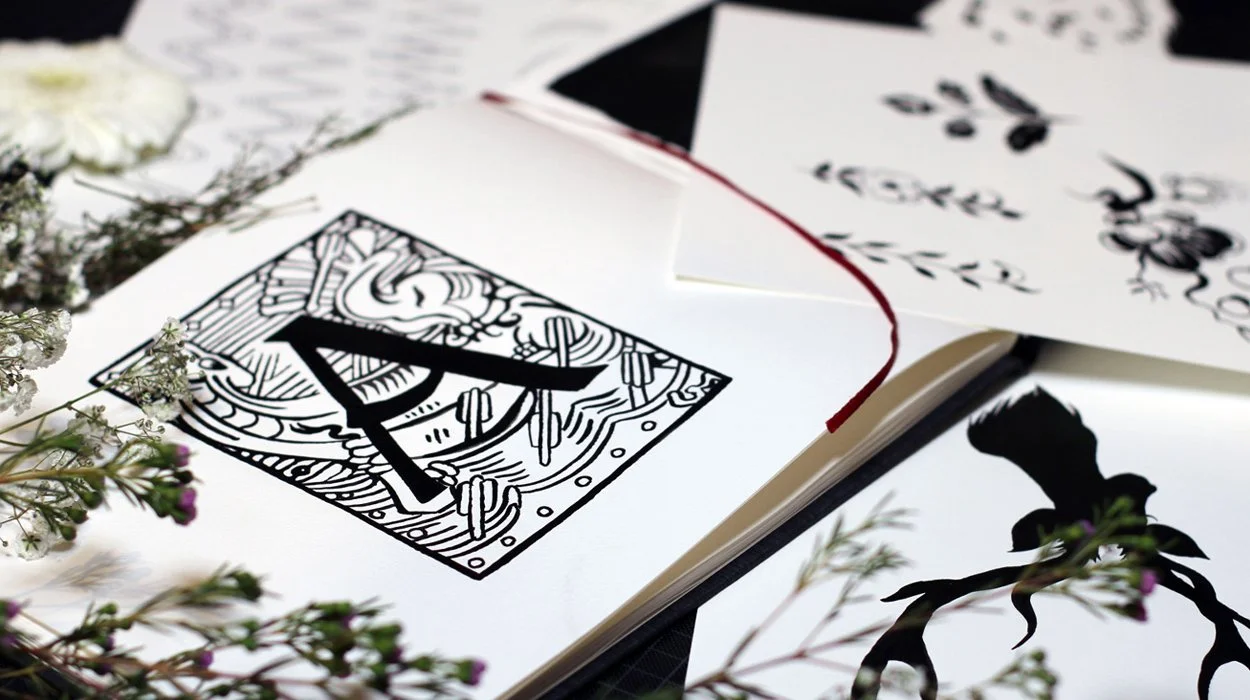 Black and white ink sketchbook page spread