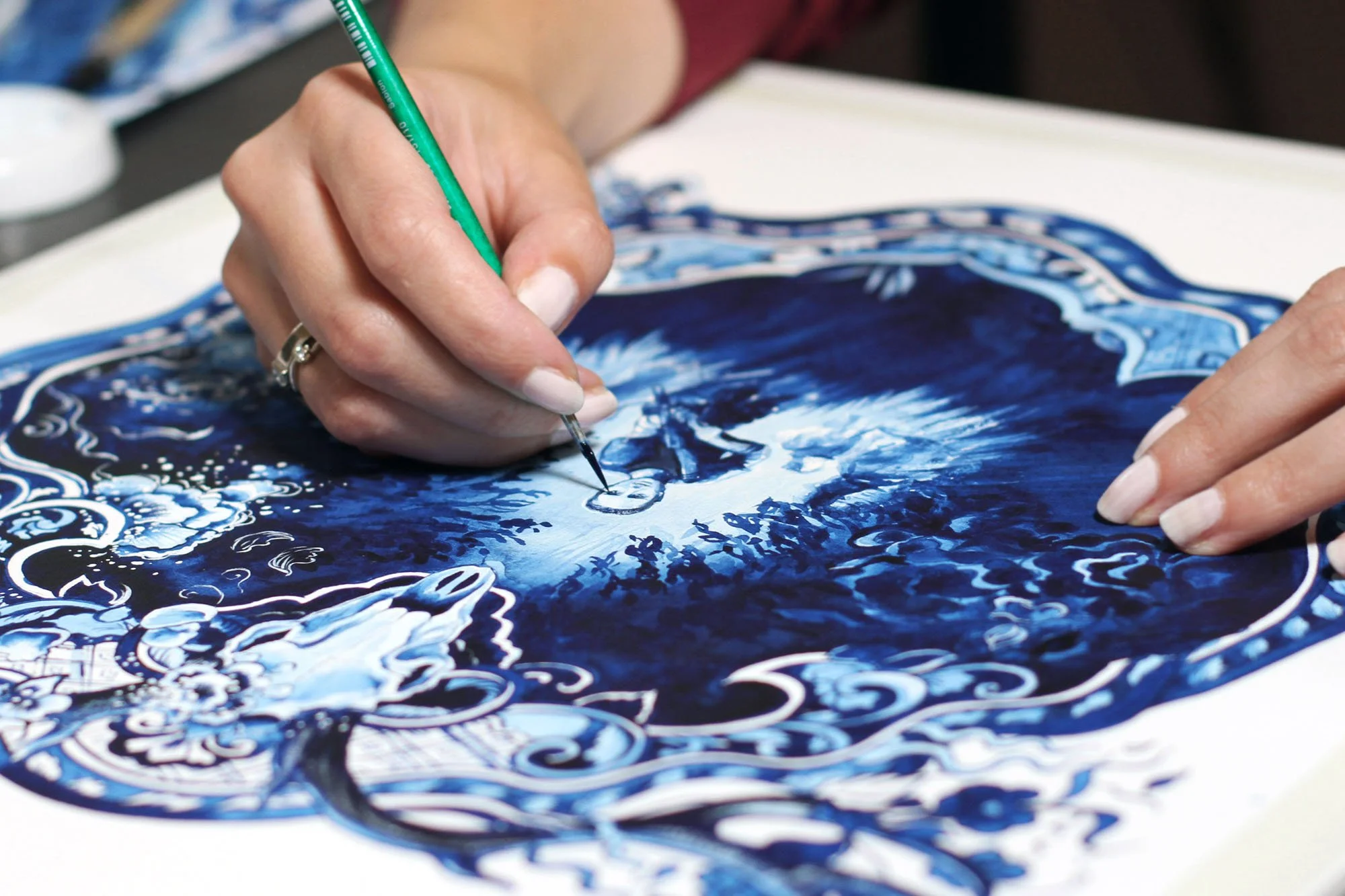 Studio view of Annihilation by Anna Sokolova showing contemporary Delft Blue brushwork and cinematic forest imagery during the painting process.