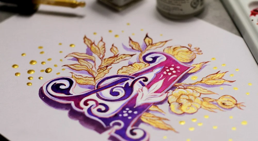 Calligraphy letter A on toned paper and gold inks with white gouache highlights