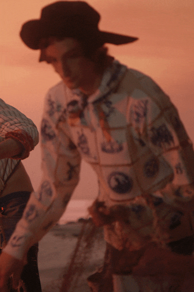 Close-up film still of Maison Margiela Artisanal hand-painted garment featuring Delft Blue-inspired illustrations by Anna Sokolova.