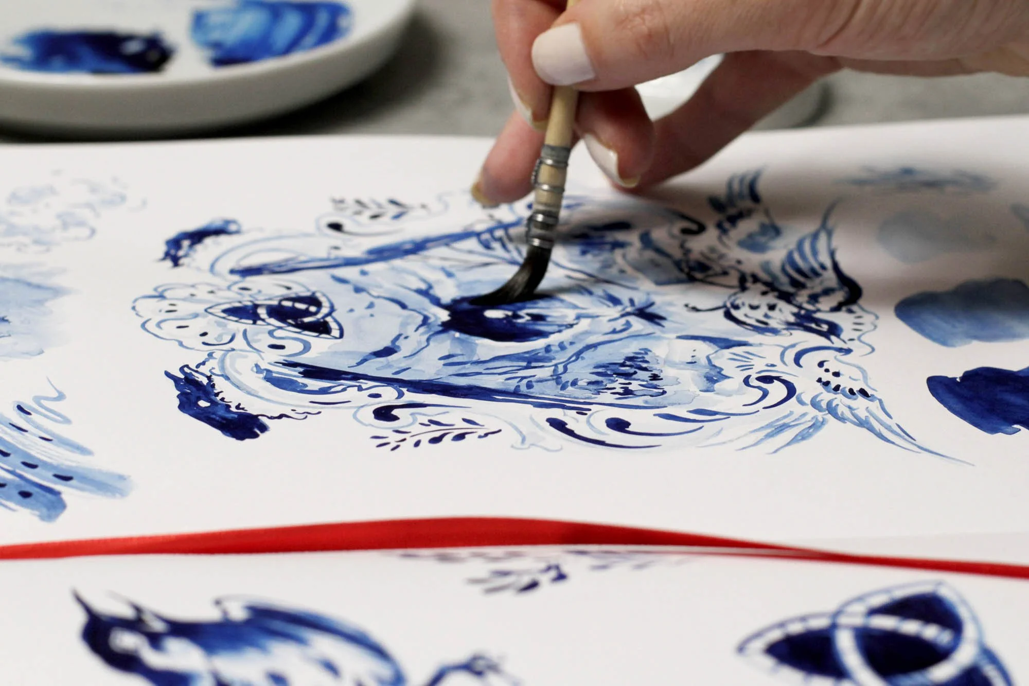 Detail of Dark by Anna Sokolova showing contemporary Delft Blue brushwork, the triquetra symbol and atmospheric forest imagery during the painting process.