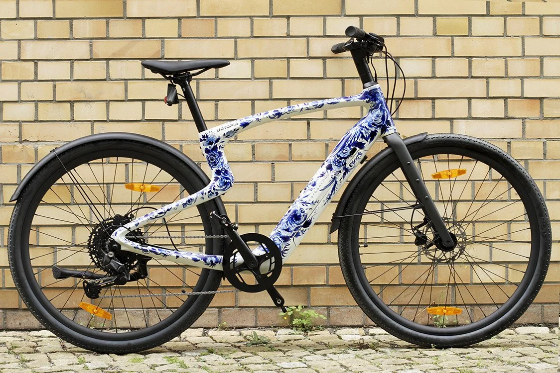 Urban Bestiary, a hand-painted Urtopia Carbon Pro eBike by Anna Sokolova featuring mythological creatures in her Contemporary Delft Blue style.