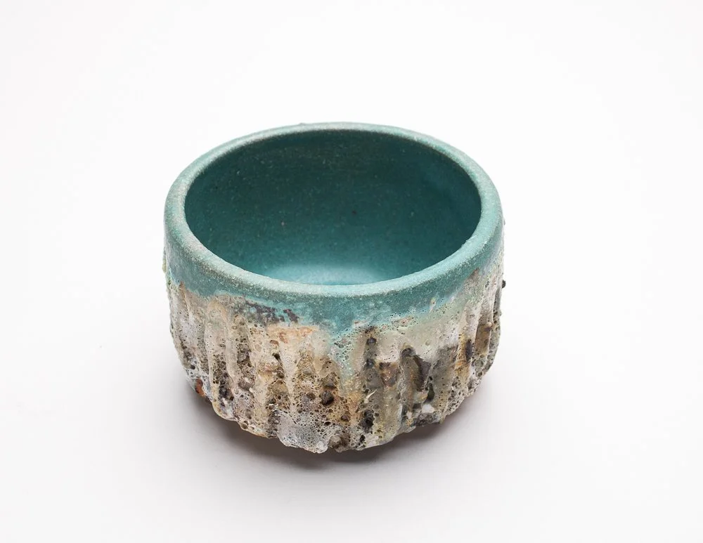 heavily textured chawan with turquoise blue interior and carved sides