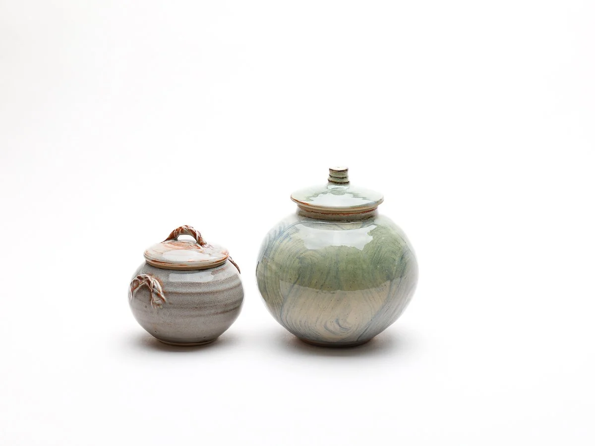lidded moon jar with multicoloured green, white and blue patterned details