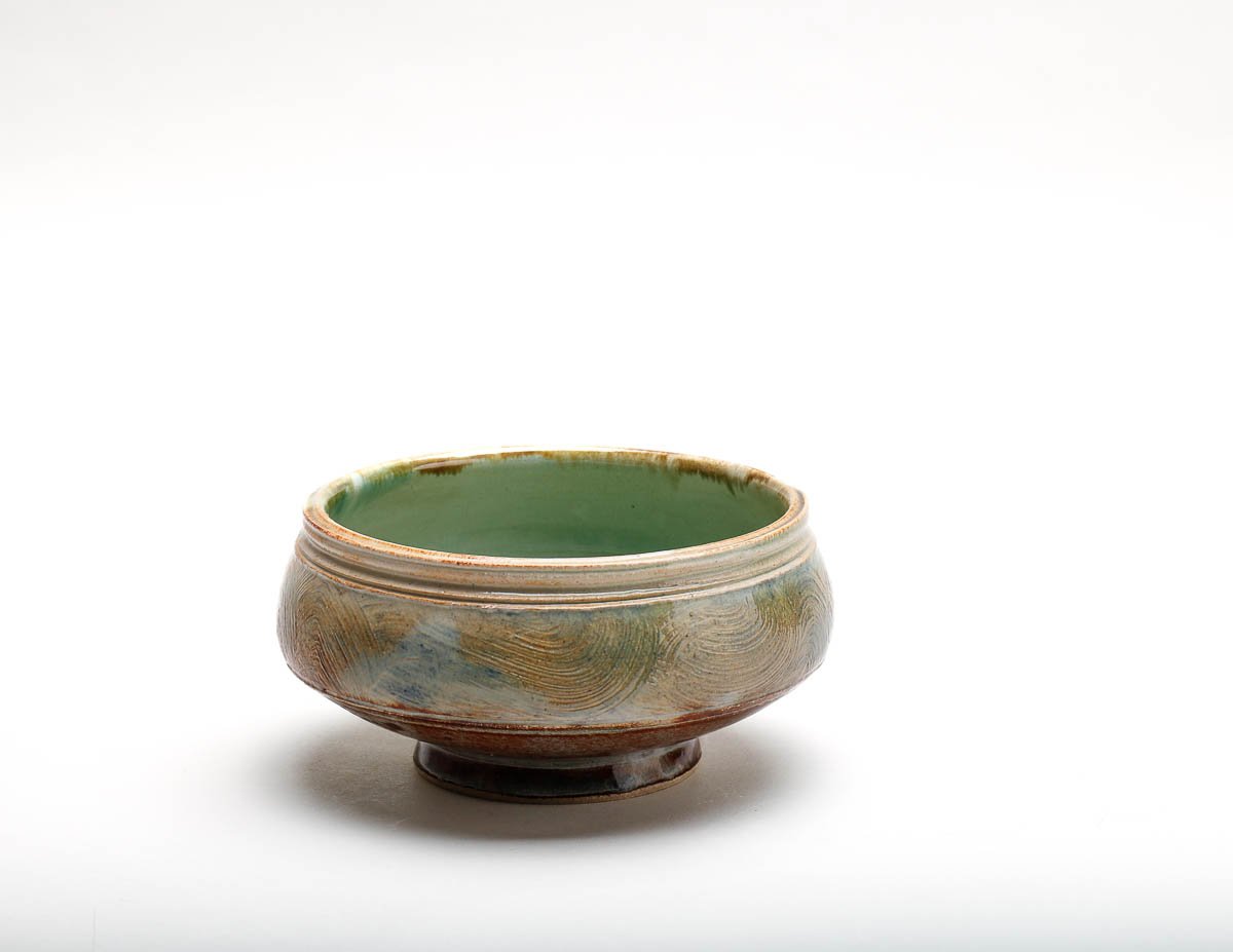 bowl with green glazed inside and brown-green-yellow glazed outside.