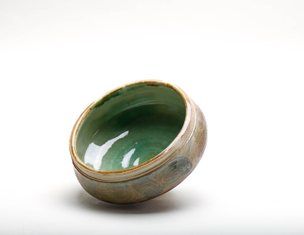 bowl with green glazed inside and brown-green-yellow glazed outside.