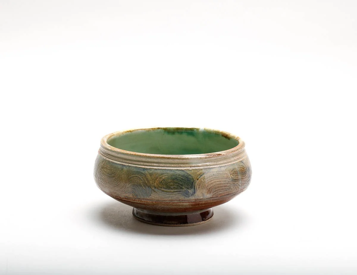 bowl with green glazed inside and brown-green-yellow glazed outside.