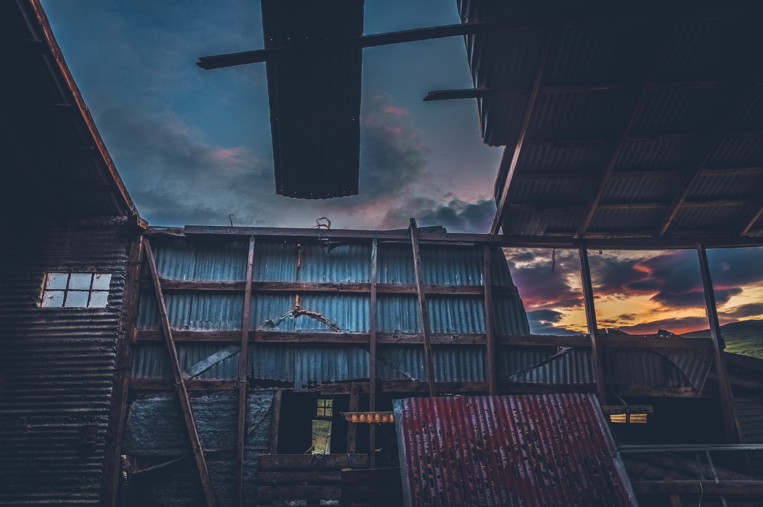 Sunset through an abandoned farm shed in Reykholt.jpg