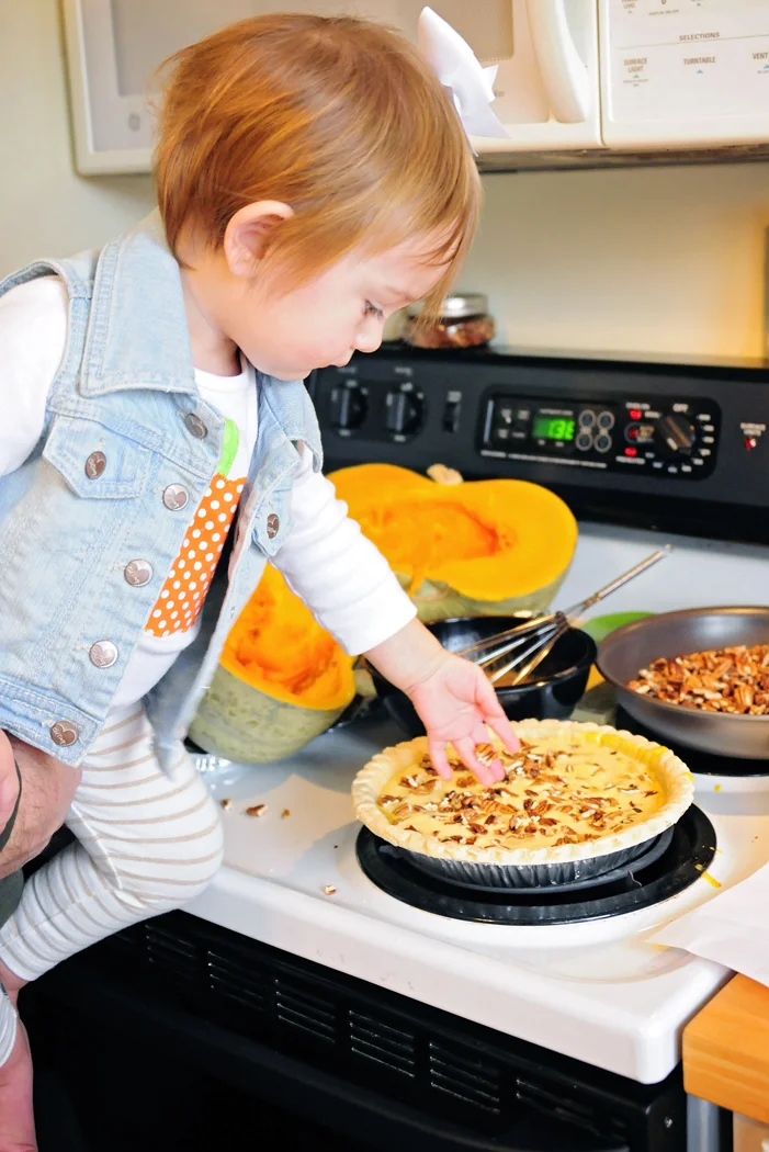 Getting a little assistance from dad to sprinkle in the pecans.
