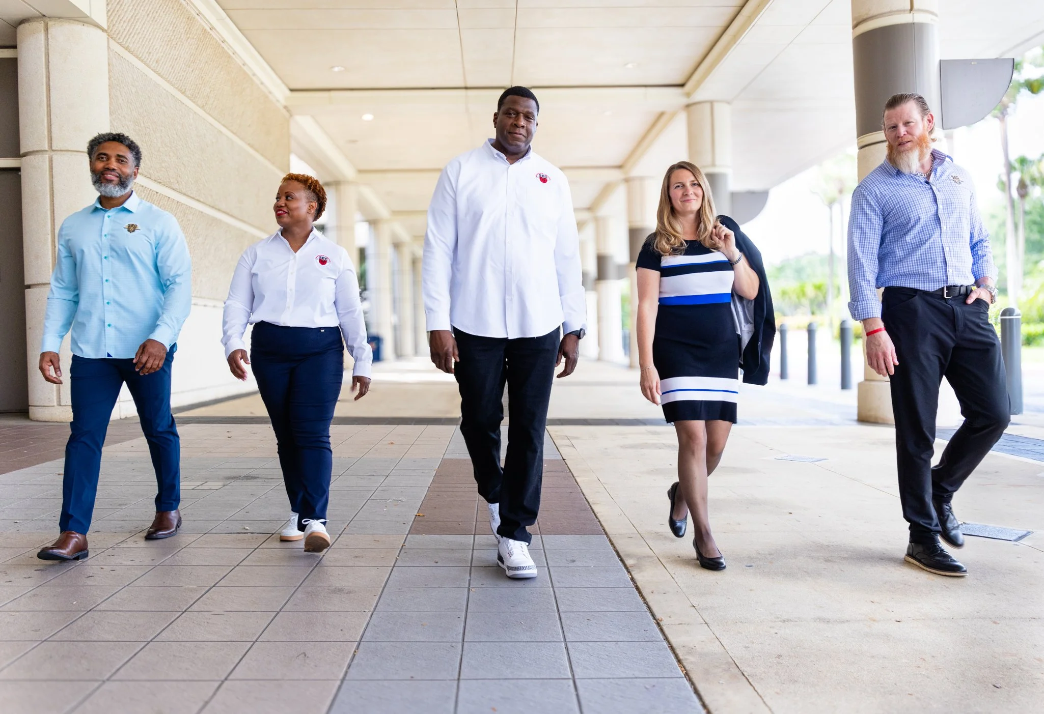group of colleagues walking together down an outside corridor