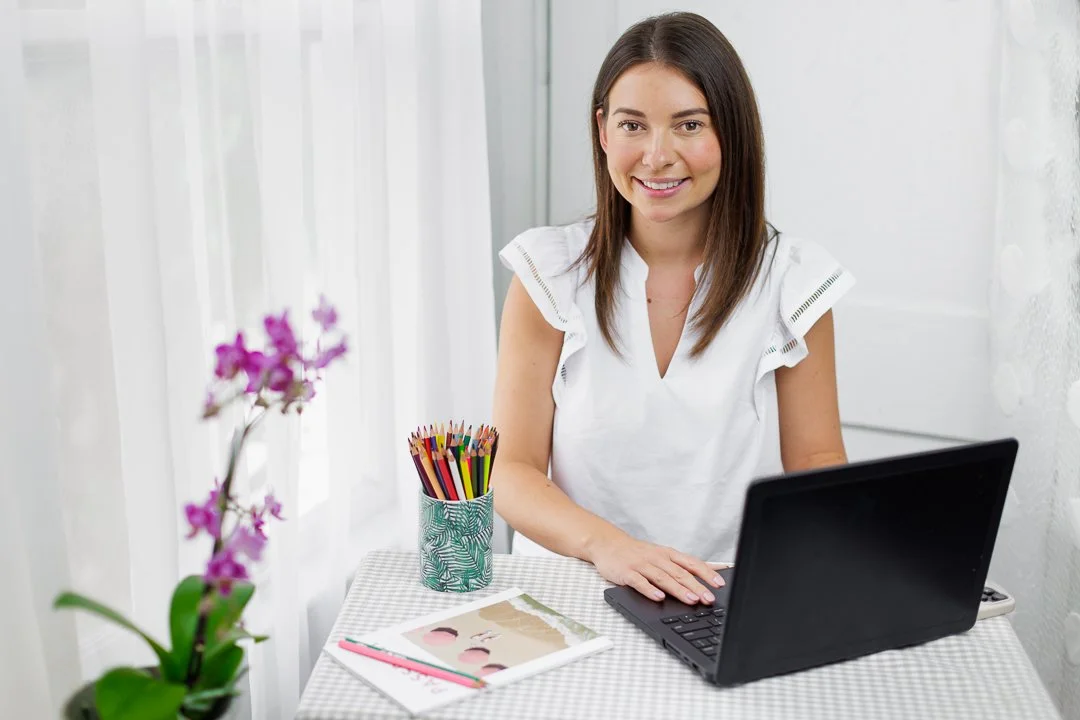 branding photographer in studio with computer and white background