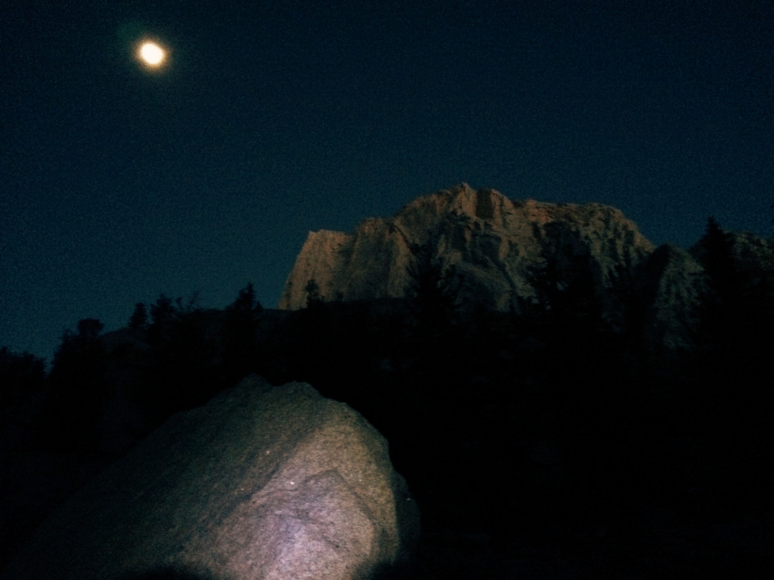 The moon was still high up in the sky as the first hints of sunlight began to illuminate the mountains. 