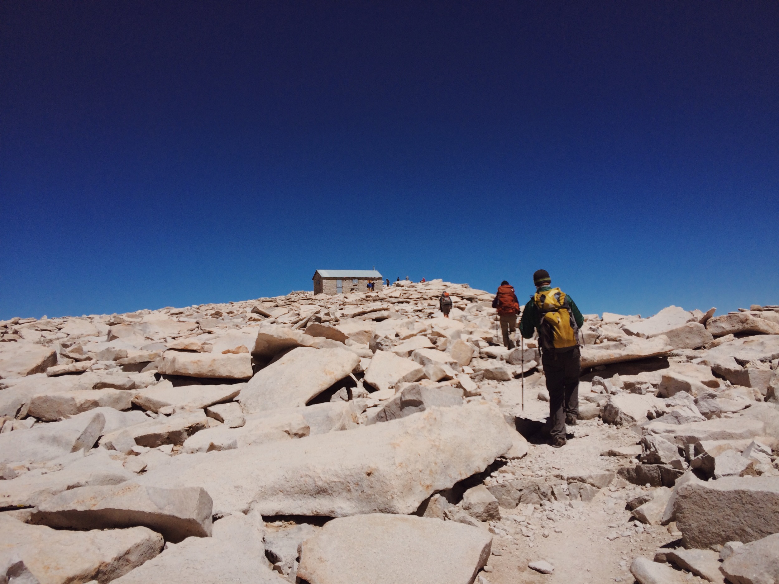  Taking the last few steps to the summit of Mt. Whitney (14,505'), the southern terminus of the JMT. Yes, the sky really was that blue. 