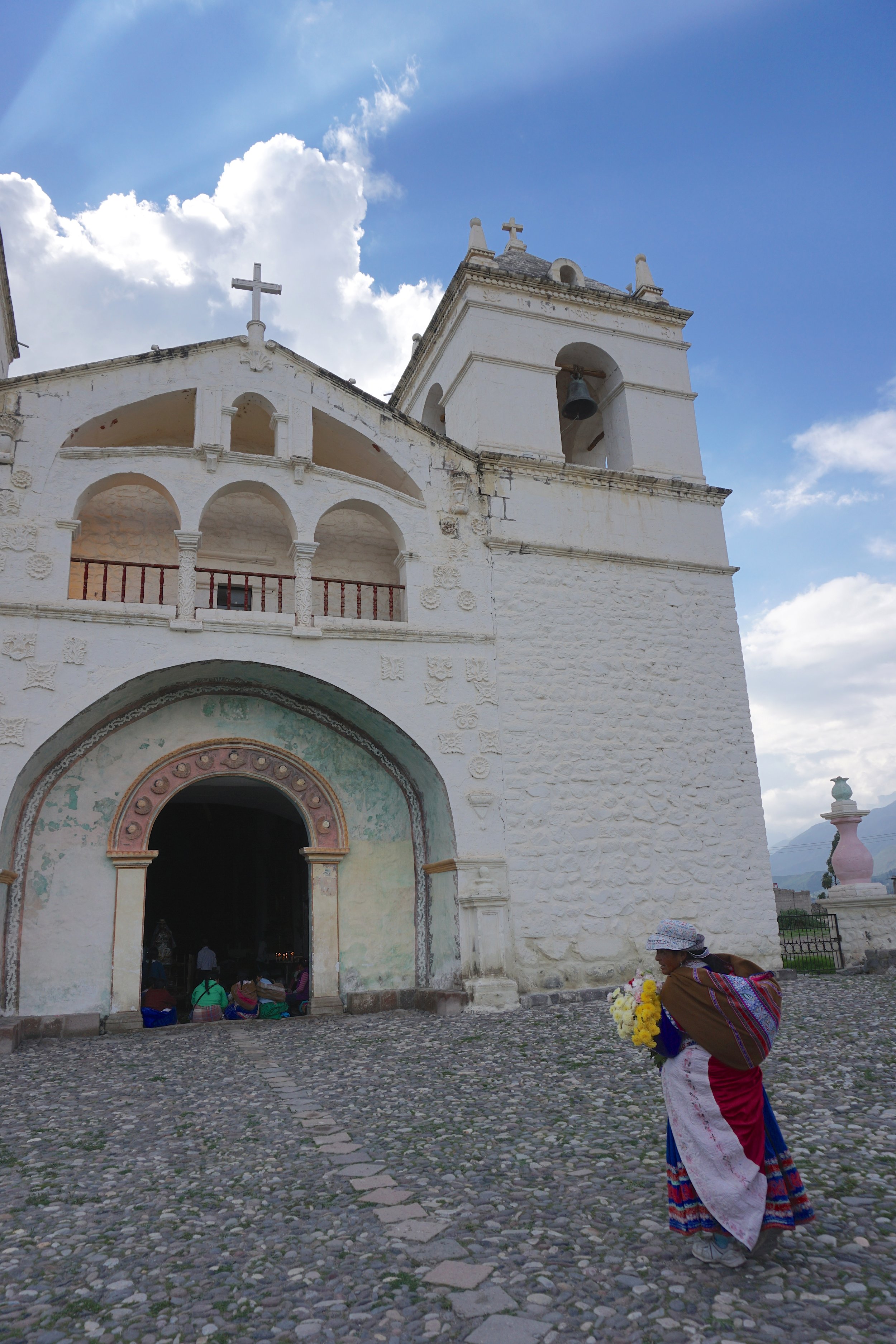  A local woman approaching the town church of Maca in the Colca Valley, on the eve of the Fiesta de la Virgen de Candelaria 