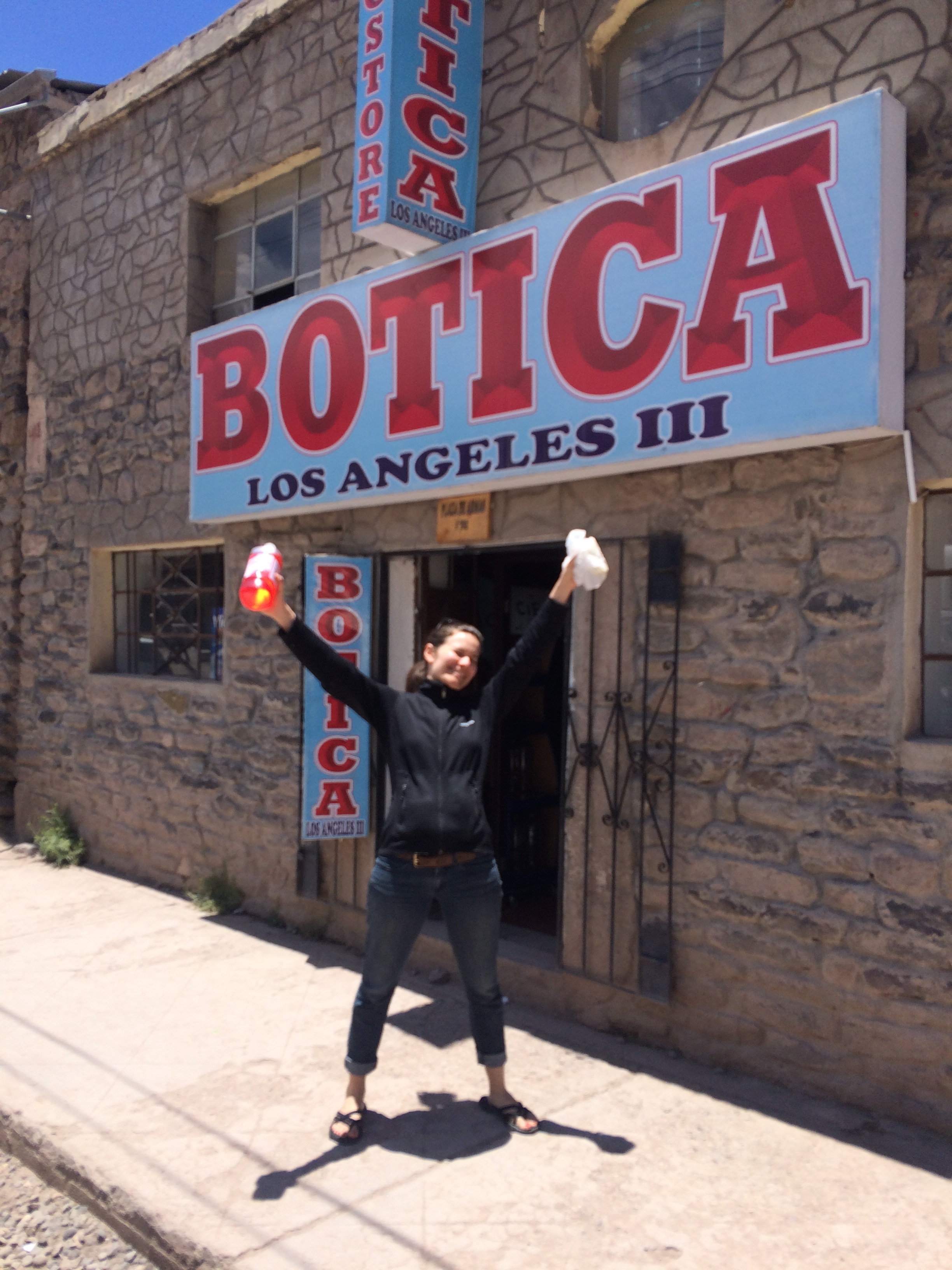 A victorious E holding electrolytes and antibiotics outside a pharmacy in Chivay, happy to begin curing an ailment you don't want to read about. 