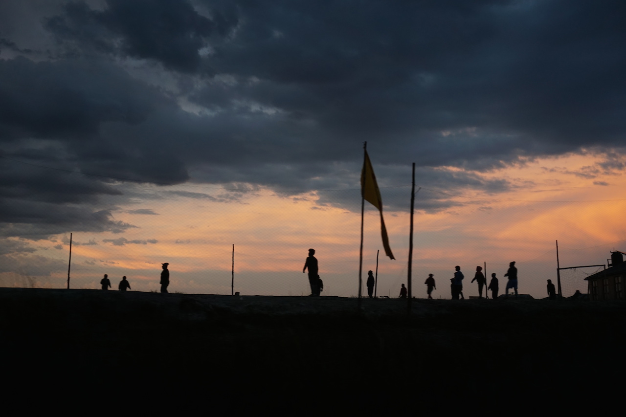  Kids on an island playing ball at sunset as seen from our boat.&nbsp; 