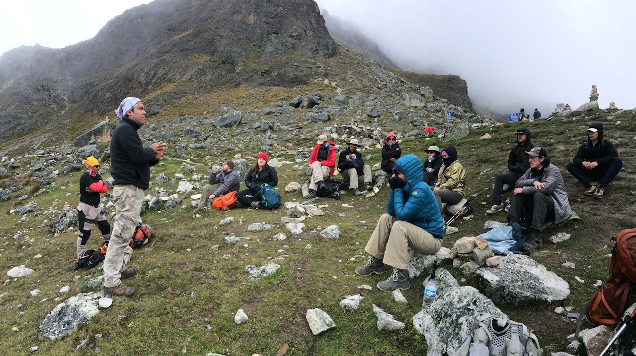  Our guide sharing knowledge with our weary group at Salkantay Pass.&nbsp; 