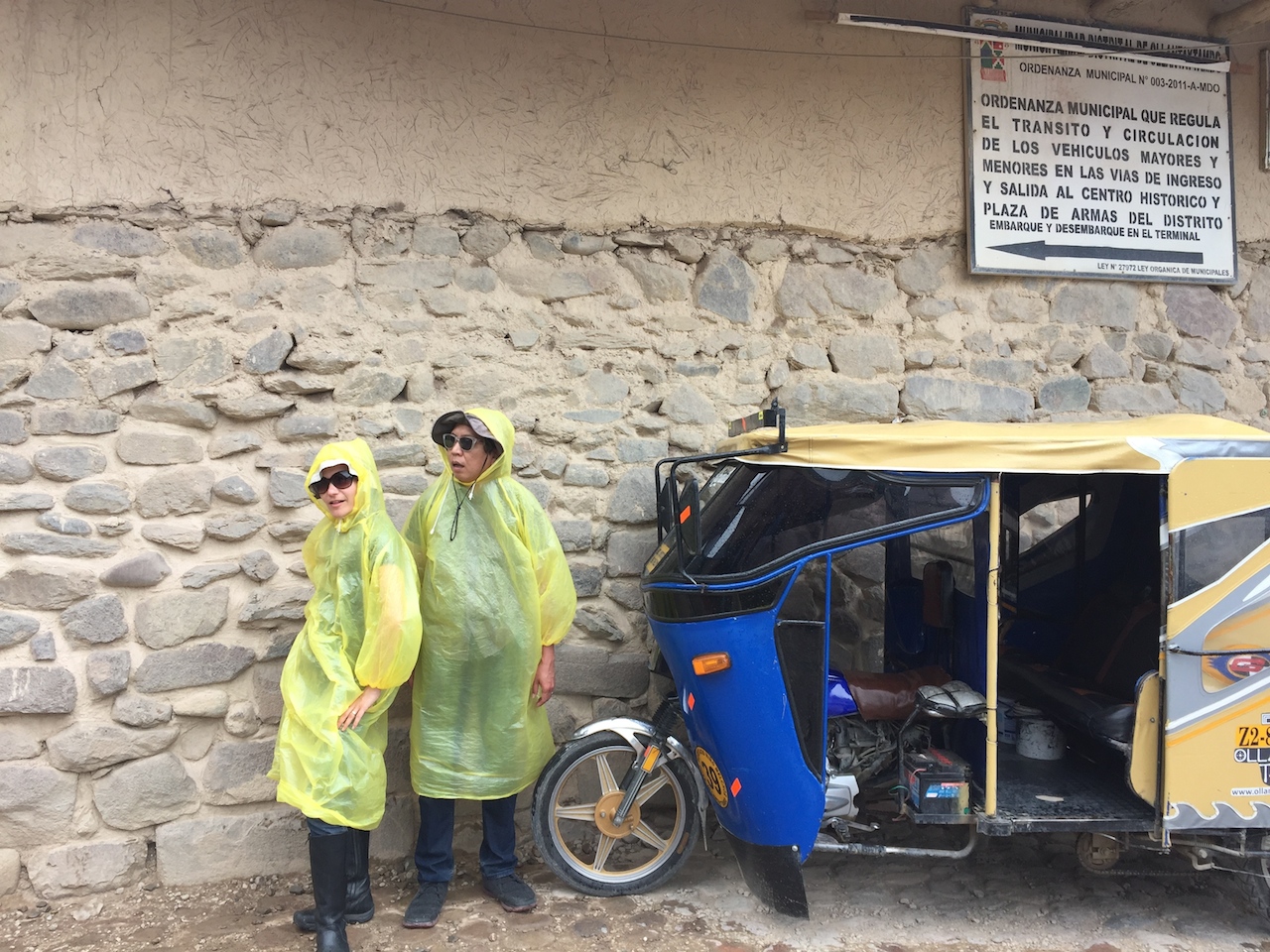  The travelers sporting fashionable disposable ponchos in Ollantaytambo. 