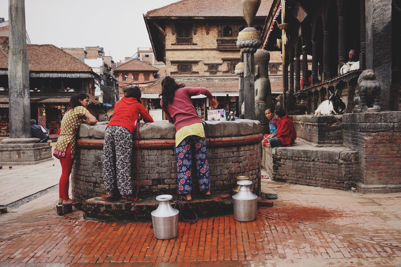  Nepali girls getting water out of a well in Durbar Square 