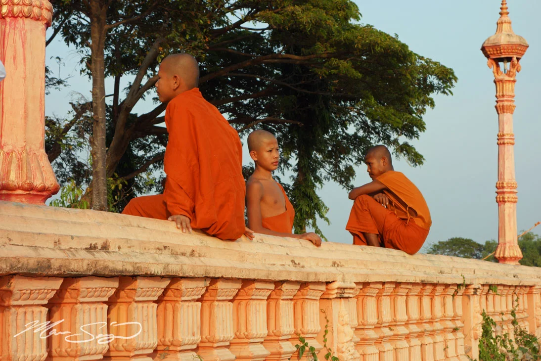 Monks resting near a small temple