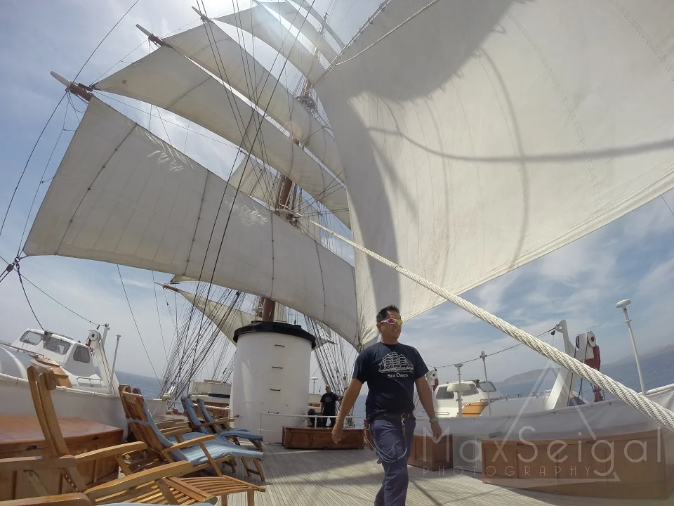 The crew prepares to take down the sails...