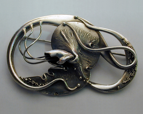 Fluid, organic, free-form brooch.