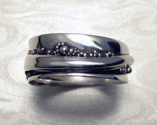 Wrap-a-round wedding ring with granulation.