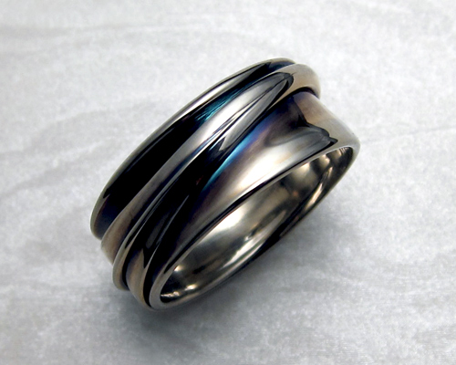 White gold band, continuous wrap with patina.