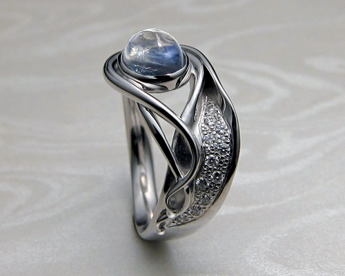 Contemporary, Art Nouveau style engagement ring with blue moonstone.
