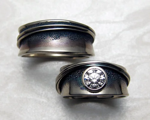 Band style engagement ring with matching gents wedding band.