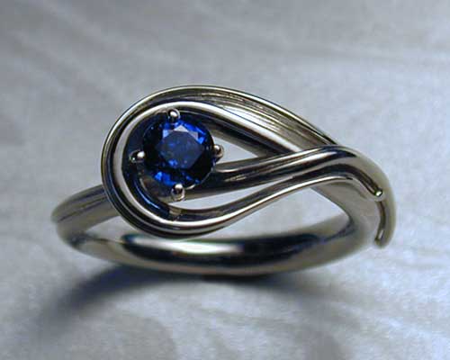 Fluid, freeform, sapphire engagement ring.